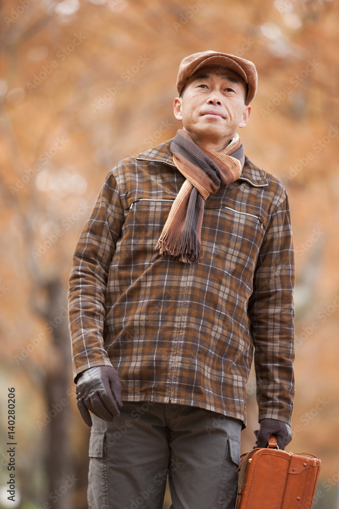 Mature Man Walking In the Woods In Autumn Mature Man Walking In the Woods In Autumn