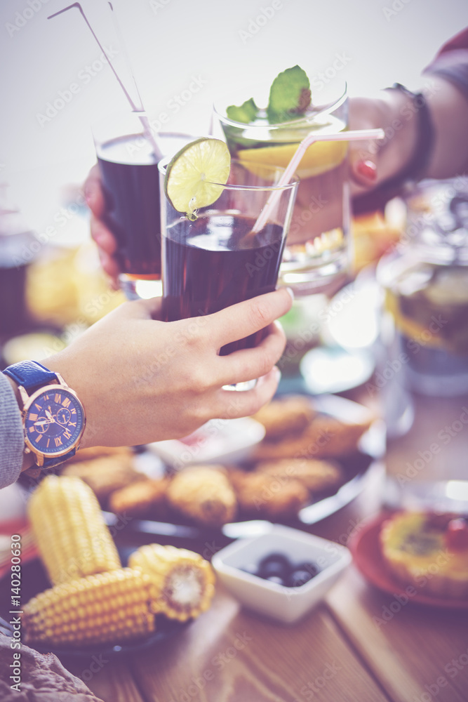 People with drinks while sitting at the dining table People with drinks while sitting at the dining table