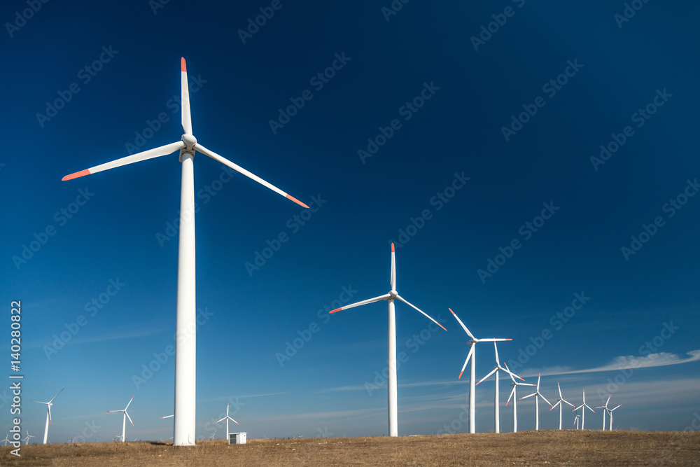 Wind turbines against a blue sky generating electricity Wind turbines against a blue sky generating electricity