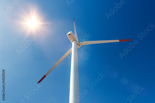 Wind turbines  against a blue sky generating electricity