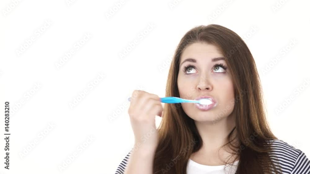 Woman dark long hair brushing cleaning teeth. Positive girl with toothbrush. Oral hygiene. Studio shot isolated on white background 4K ProRes HQ codec Woman dark long hair brushing cleaning teeth. Positive girl with toothbrush. Oral hygiene. Studio shot isolated on white background 4K ProRes HQ codec
