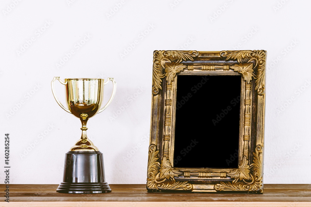 Golden trophy on wooden table with copy space Golden trophy on wooden table with copy space