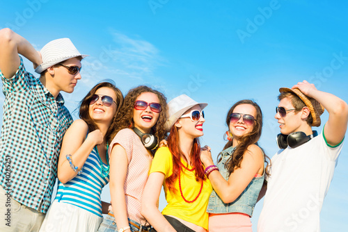 group of young people wearing sunglasses and hat