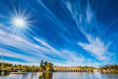 Thin cirrus clouds is reflected in river photo