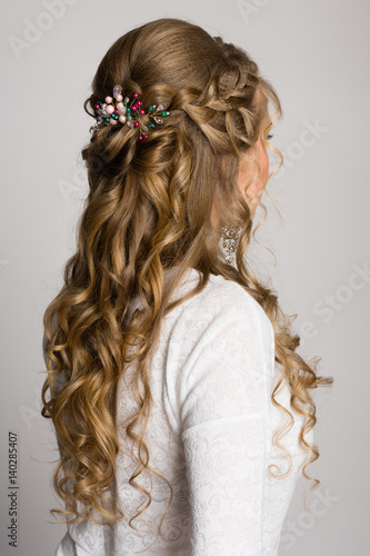 Portrait of a girl with a long trendy hairstyle sideways