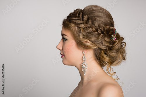 Young blonde with naked shoulders in profile