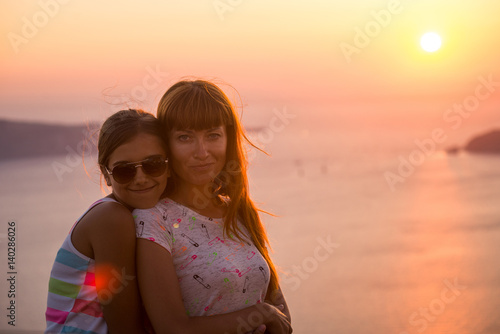 Mother and daughter at sunset. 