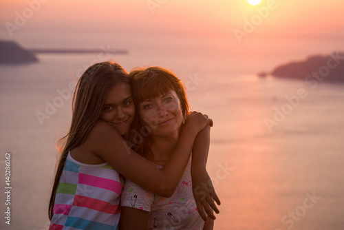 Mother and daughter at sunset. 