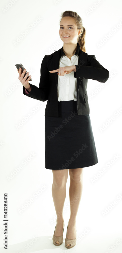Smiling business woman shows finger on smartphone. White background
Smiling business woman shows finger on smartphone. White background