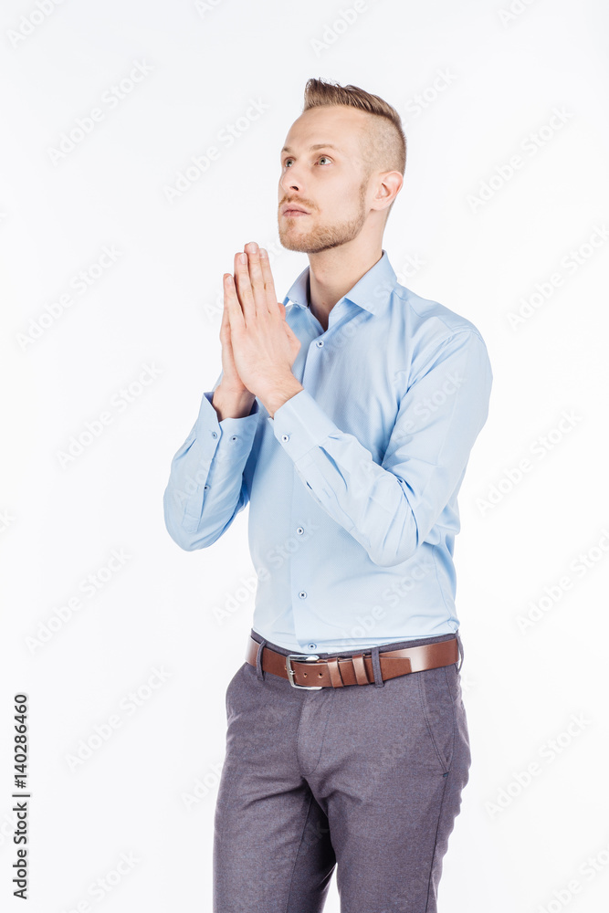 bearded business man praying with hands. human emotion expression and lifestyle concept. image on a white studio background.. bearded business man praying with hands. human emotion expression and lifestyle concept. image on a white studio background..
