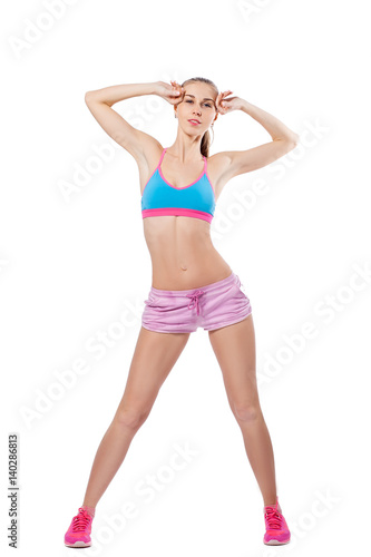 A young slender woman is engaged in fitness. Isolated white background © Виталий Сова