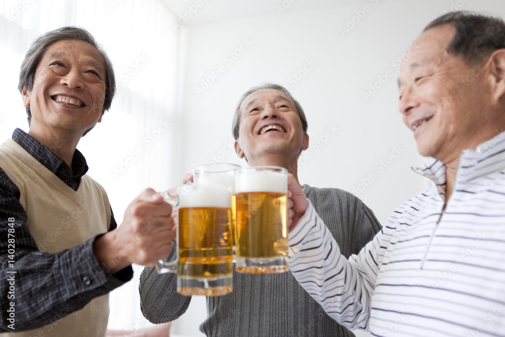 Three Senior Men Toasting with Pint Three Senior Men Toasting with Pint