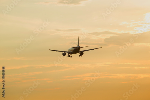 Passenger plane flies in the evening sky