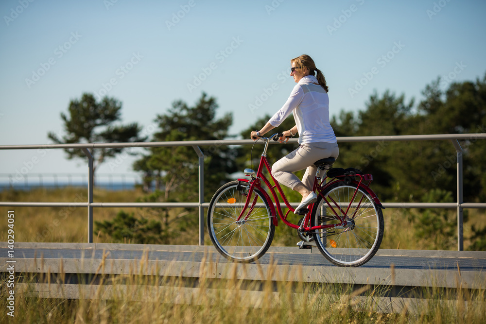 Fototapeta premium Woman riding bike outdoor