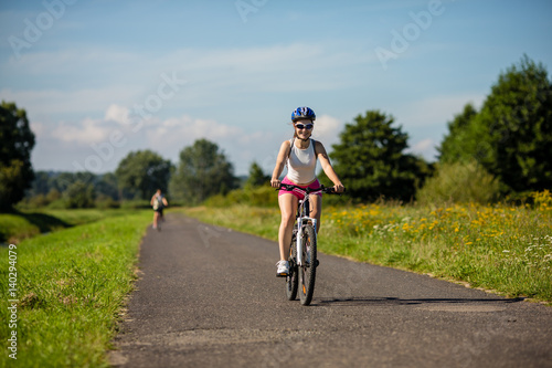 Fototapeta Naklejka Na Ścianę i Meble -  Young woman cycling outdoor