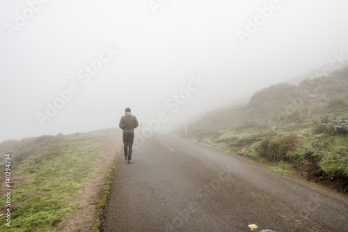 Lone man walking through the white fog © haveseen