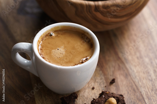 Fototapeta Naklejka Na Ścianę i Meble -  cup of fresh espresso with homemade chocolate cookie with hazelnuts, shallow focus
