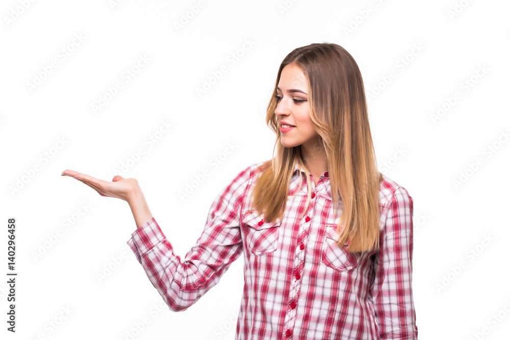 Girl shows a hand advertising. Woman with outstretched hand. Beautiful girl. Beautiful portrait of a girl in a plaid shirt over a white background. Space for text Girl shows a hand advertising. Woman with outstretched hand. Beautiful girl. Beautiful portrait of a girl in a plaid shirt over a white background. Space for text