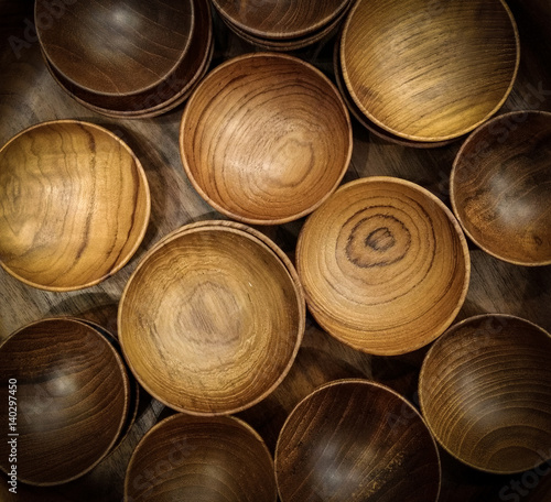 Wooden cups and bowls on top view.