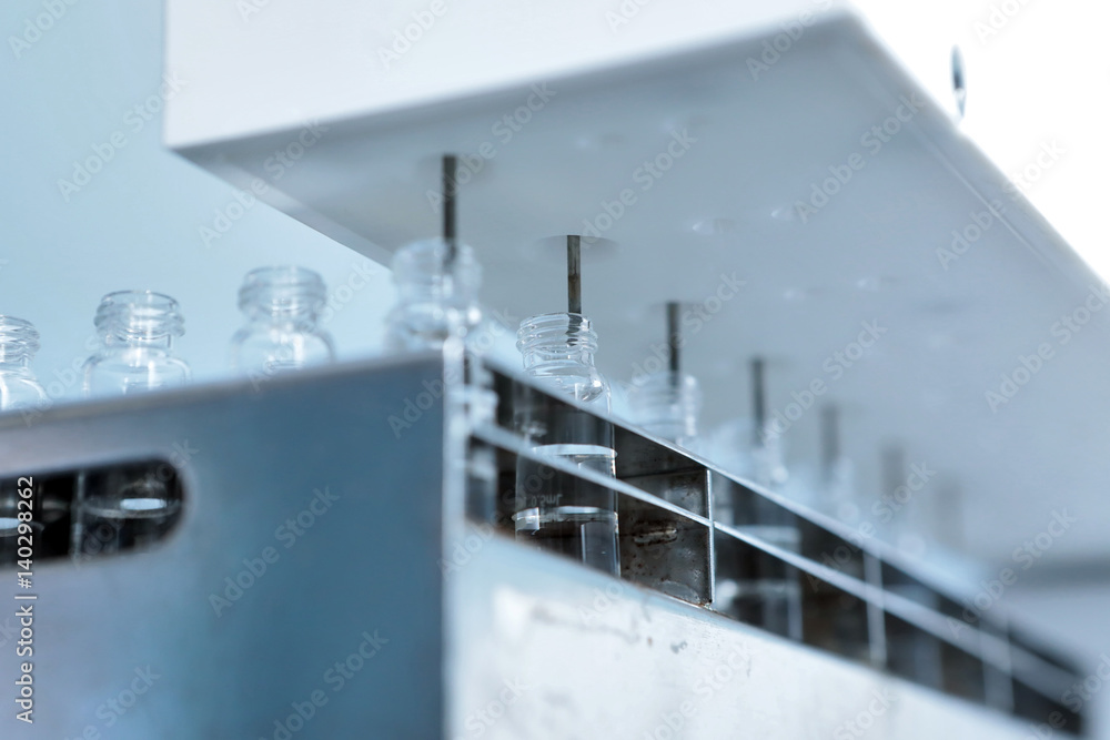 Sterile capsules for injection. Bottles on the bottling line of the pharmaceutical plant. Machine after checking sterile liquids. Interferon, nasoferon.