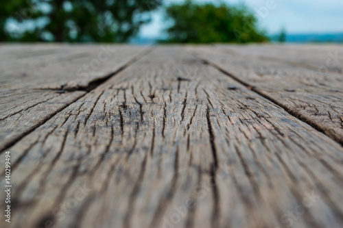Wooden floor over a beautiful blurred nature