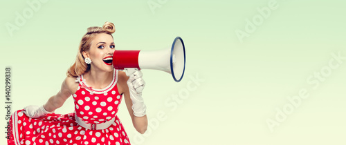happy woman holding megaphone, dressed in pin-up style red dress