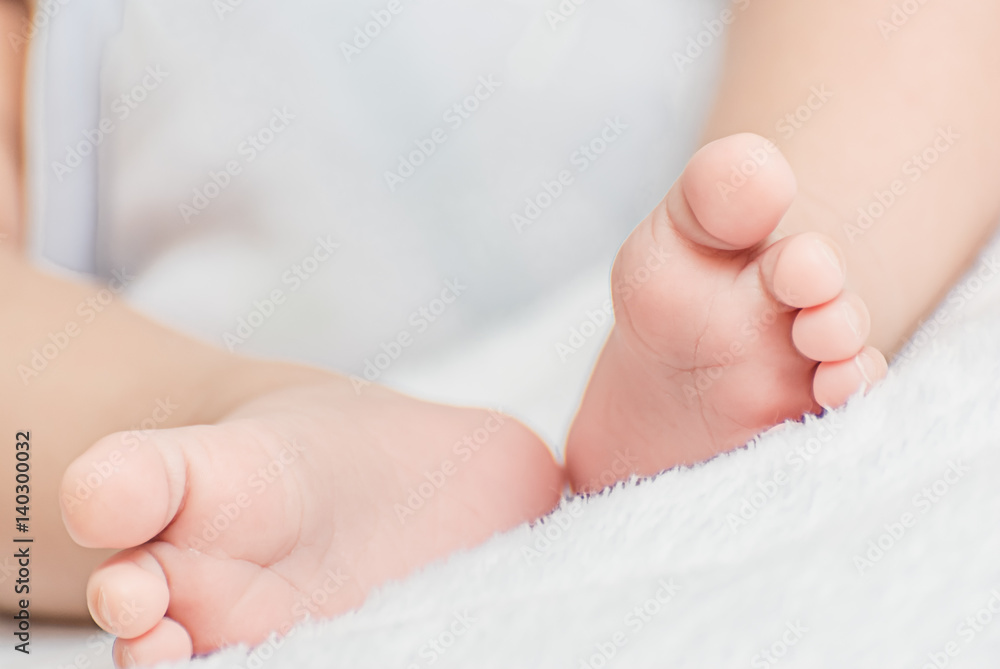 Close-up of mother hands holding tiny baby feet Close-up of mother hands holding tiny baby feet