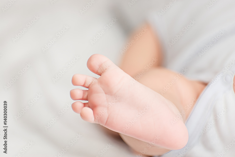 Close-up of mother hands holding tiny baby feet Close-up of mother hands holding tiny baby feet