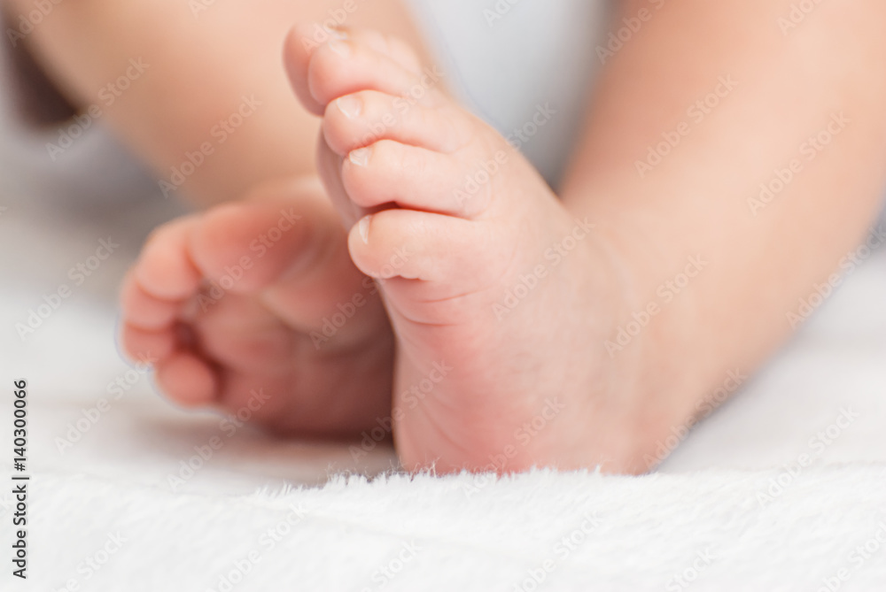 Close-up of mother hands holding tiny baby feet Close-up of mother hands holding tiny baby feet