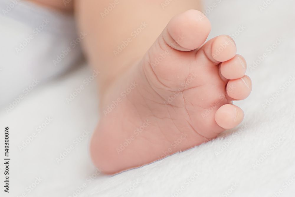 Close-up of mother hands holding tiny baby feet Close-up of mother hands holding tiny baby feet