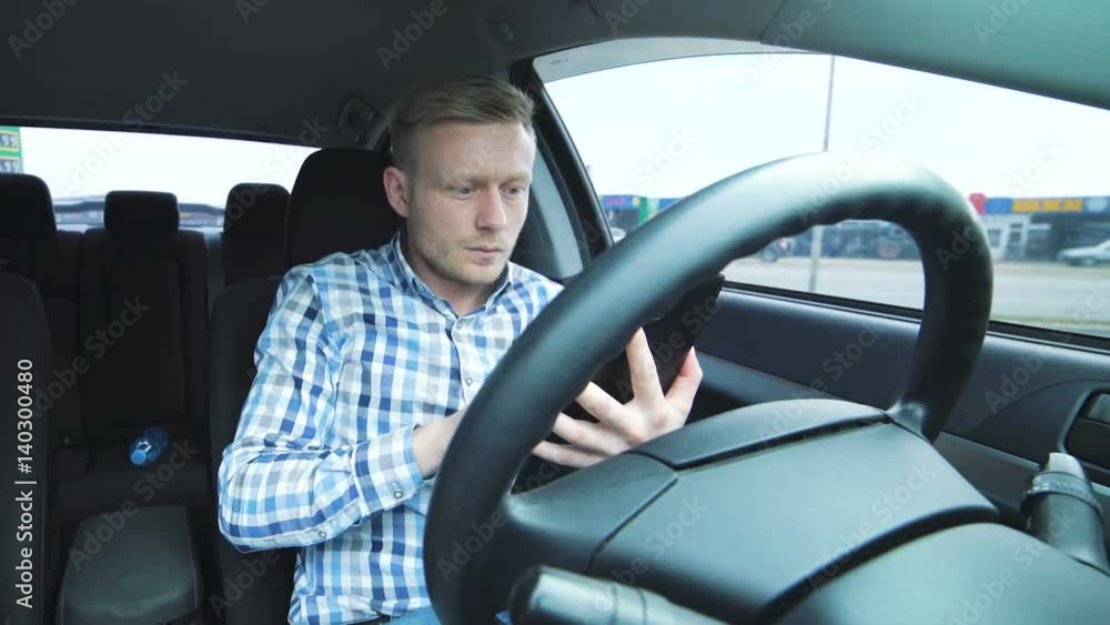 Young man uses tablet in the car Young man uses tablet in the car