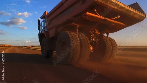 Dump truck rides on the road to the quarry. Moving camera.