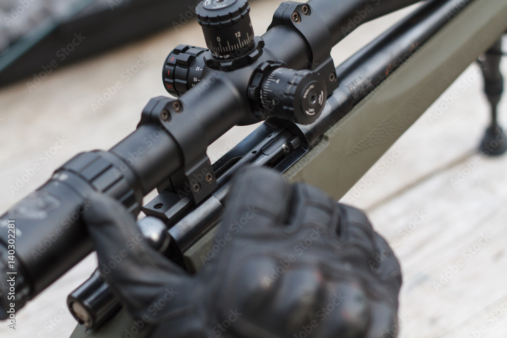 A man shoots a rifle. Rifle shooting with optical sight outdoors by man. A man shoots a rifle. Rifle shooting with optical sight outdoors by man.