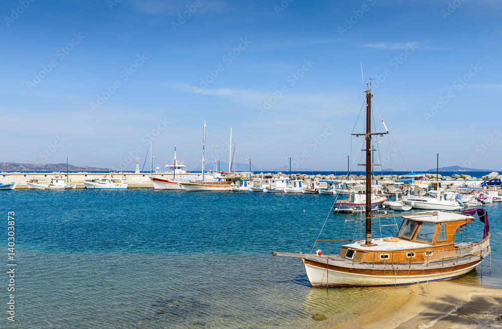 The picturesque Harbor with fishing boats in a sunny summer day, Kefalos village, Kos island, Dodecanese, Greece
