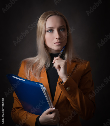 Business woman portrait on dark background.