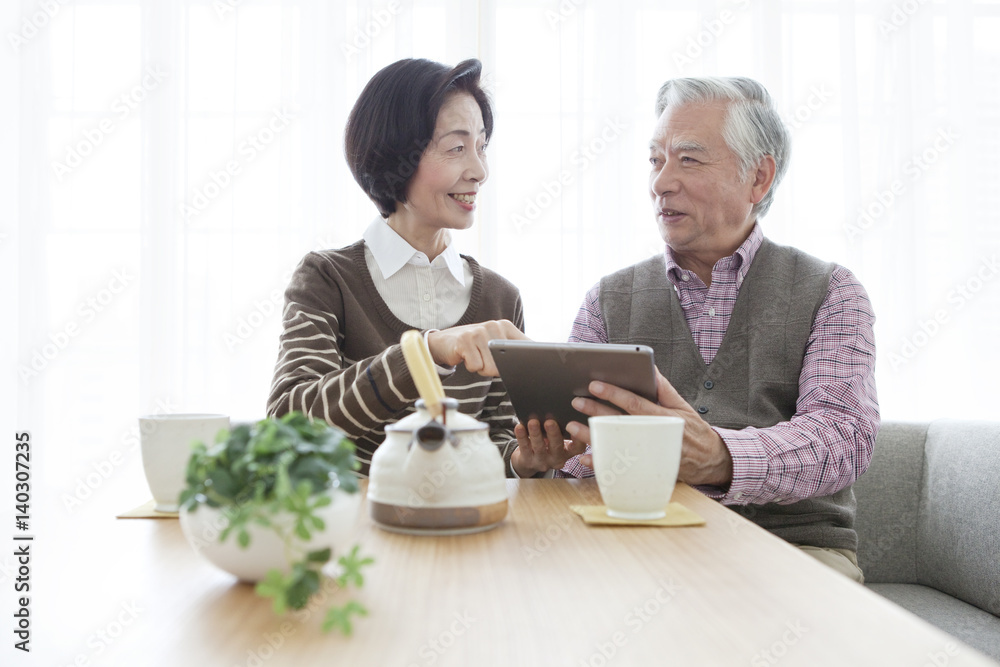 Senior couple looking at tablet PC Senior couple looking at tablet PC