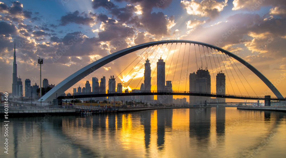 Dubai, UAE - March 4, 2017: Magical sunrise over Dubai Downtown as viewed from the Dubai water canal Dubai, UAE - March 4, 2017: Magical sunrise over Dubai Downtown as viewed from the Dubai water canal