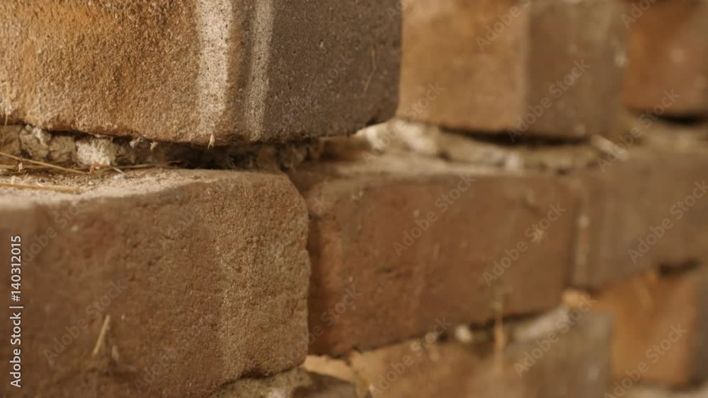 Rows of old bricks headers and stretchers close-up 4K 2160p 30fps UltraHD footage - Weathered house wall texture details shallow DOF tilt 3840X2160 UHD video Rows of old bricks headers and stretchers close-up 4K 2160p 30fps UltraHD footage - Weathered house wall texture details shallow DOF tilt 3840X2160 UHD video