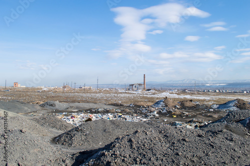Abandoned factory and garbage pile in trash dump.