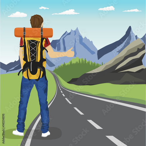rear view of young man doing hitchhiking on road in mountains