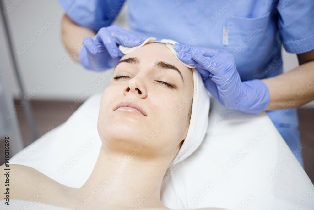 Beautiful woman at spa salon, Cosmetician woman applying facial mask. Beautiful woman at spa salon, Cosmetician woman applying facial mask.