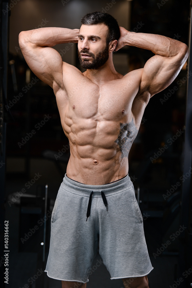 Fototapeta premium Caucasian sexy fitness model in gym close up abs.