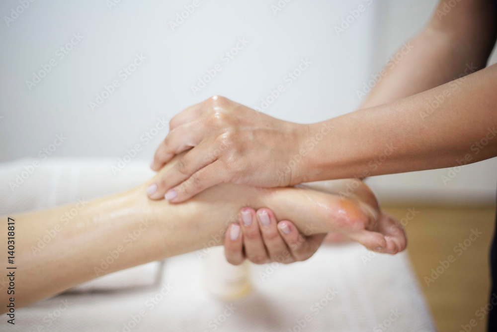 Fototapeta premium Woman receiving a foot massage at the health spa