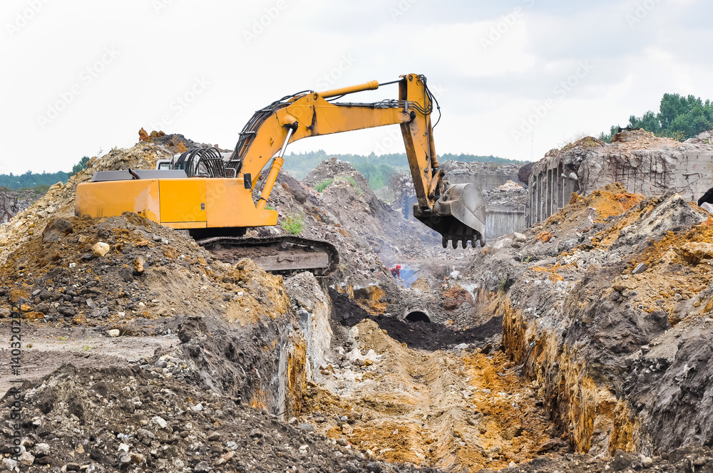 Excavator working at the demolition of an old industrial buildin