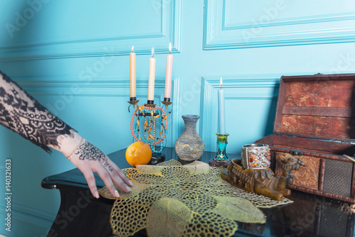 Chest, candles and a bottle on the table. photo