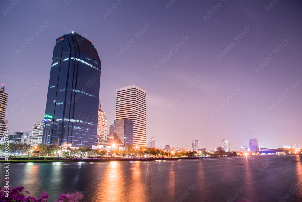 Obraz premium Bangkok city downtown at night with reflection of skyline, Bangkok,Thailand