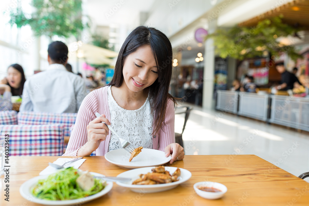 Woman enjoy her food in restaurant