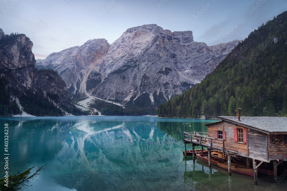 Calm atmosphere in idyllic mountain lake at dawn