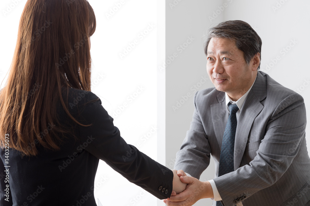 握手をするビジネスウーマンとビジネスマン、締結、成約、契約 握手をするビジネスウーマンとビジネスマン、締結、成約、契約