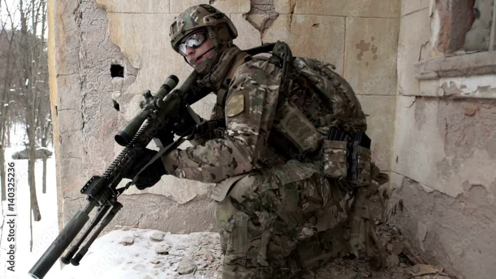 Military men with arms defending the building in winter Military men with arms defending the building in winter